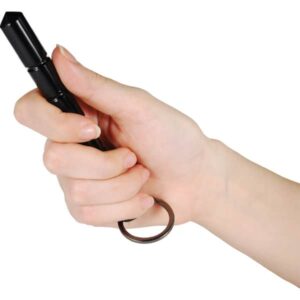 Hand holding aluminum self defense keychain Kubotan black with point extended.