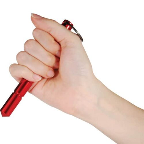 Holding aluminum self-defense keychain Kubotan Red with a secure grip and point extending down.