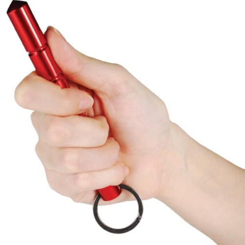 Hand holding aluminum self defense keychain Kubotan red with point extended.
